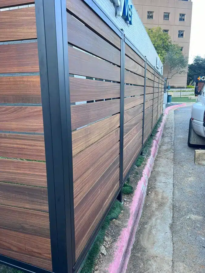 New cedar board-on-board fence installed along a sunny backyard in Frisco, TX