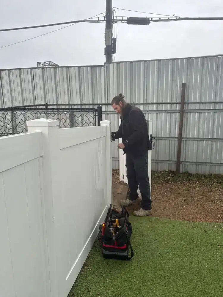 Crew repairing storm-damaged cedar pickets on a residential fence in Arlington, TX