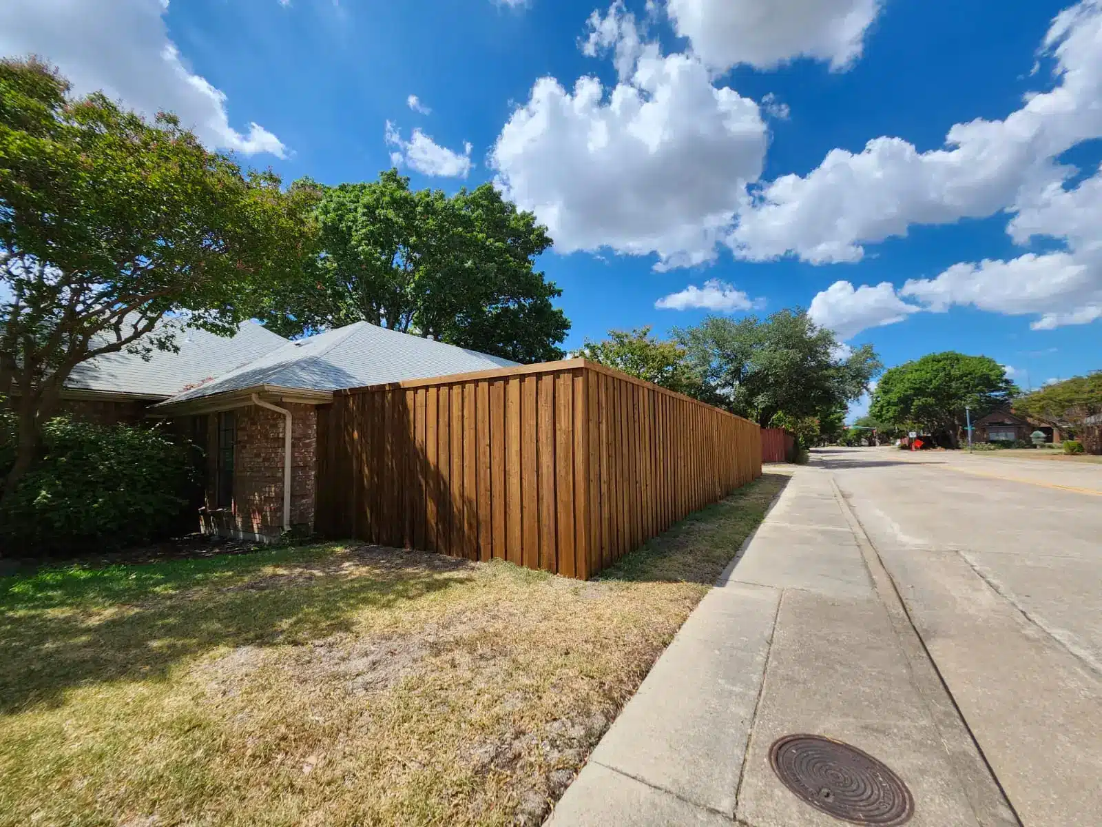 Cedar privacy fence wrapping a residential corner lot in Dallas&ndash;Fort Worth