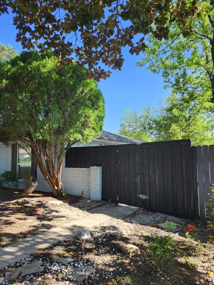 Dark stained wood gate at a front walkway entrance in DFW