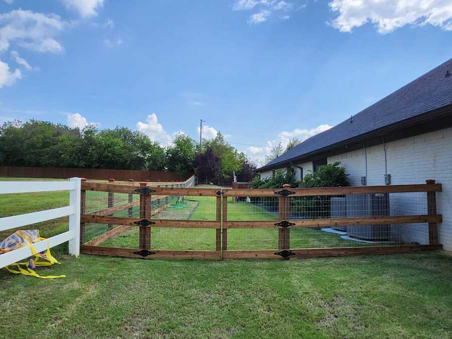Wood gate with new hinges and latch after repair in Dallas-Fort Worth